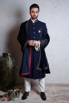 Navy blue sherwani with floral embroidered mandarin collar, cuffs and patch pocket. Paired with kurta and pant.
Component: 3
Neckline: Mandarin
Sleeve Length: Full
Fabric: Italian Crepe
Color: Blue
Embroidered collar
Front button placket
Note: Pocket square, shawl and brooch worn by the model is not for sale - Aza Fashions Wedding Matching Outfits, Blue Sherwani, Net Embroidery, Tarun Tahiliani, Embroidered Collars, Groom Wear, Boy Blue, Modern Bride, Set For Women