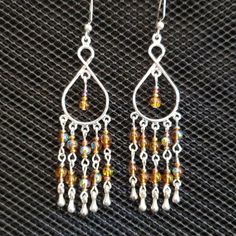 Silver Chandelier Earrings With Iridescent Topaz-Colored Beads And Silver Drops. Weight: 0 Oz/2 Grams Each. 3-3/8 Inches/8.3 Cm From Top Of Ear Wire. Ear Wires Are Silver Plated And Nickel Free. Brand-New, Never Worn Nwt. Handmade By Me, The Sparkliefiend! Gold Bead Earrings, Peach Earrings, Silver Chandelier Earrings, Malachite Earrings, Carnelian Earrings, Silver Chandelier, Cactus Earrings, Yellow Opal, Cat Earrings