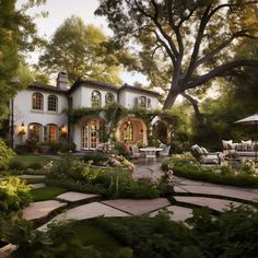 a white house surrounded by greenery and trees