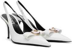 Patent calfskin heels in white. · Pointed toe · Logo hardware at bow accent · Partially elasticized slingback strap · Logo printed at lambskin footbed · Covered stiletto heel with rubber injection · Patent calfskin sole · Heel: H3 Supplier color: Optical white Slingback Heels, White Heels, Slingback Heel, Designer Heels, Stiletto Heel, Stiletto Heels, Calf Skin, Versace, White And Black