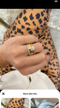 a woman's hand with a gold and white diamond ring on her left finger