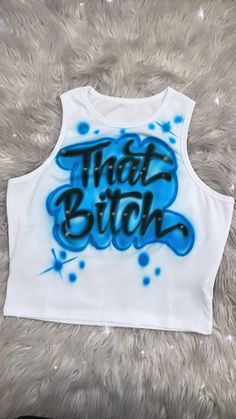 Designs by Galveston Airbrush! ♡ Feel free to contact me with any questions or custom orders. ✧ Our Designs on these cute Crop tops are handmade with the artists' skilled Hands and that makes each item unique ✧ Each design includes up to TWO names or words with up to THREE specified COLORS. SIZES: Available for ADULTS DESIGN PLACEMENT: All designs are airbrushed on the FRONT of the crop top unless specified otherwise. International orders will have an additional shipping charge. WASHING INSTRUCT Airbrush Crop Top, Trendy Screen Print Tank Top For Streetwear, Trendy Graffiti Print Summer Tops, Y2k White Tops With Graffiti Print, Y2k White Top With Graffiti Print, Blue Y2k Crop Top For Streetwear, Trendy Blue Top With Sublimation Print, Blue Cotton Tops With Graffiti Print, White Fitted Tops With Graffiti Print