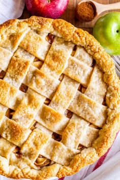 an apple pie sitting on top of a wooden table