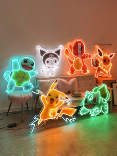 a room filled with lots of different types of light up pokemon signs on the wall