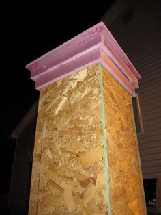 the corner of a building that is covered in plywood