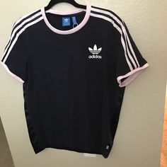 Adidas Size Medium Navy Blue With Light Pink Stripes Old School Logo Blue Tag T-Shirt 2 Materials The Back Is Sleek Front Is Jersey Knit New Without Tags ** Flawed** One Small Hole In The Seam At The Bottom Back In Photos Adidas Three Stripes Summer Tops, Adidas Summer Tops With Three Stripes, Spring Adidas Athleisure T-shirt, Adidas Athleisure T-shirt For Spring, Blue Three Stripes Tops For Summer, Spring Adidas Three Stripes Top, Adidas Casual Tops With Three Stripes Branding, Adidas Tops With Three Stripes For Spring, Short Sleeve Tops With Three Stripes For Spring