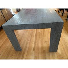 a wooden table sitting on top of a hard wood floor