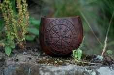 a wooden bowl sitting on top of a rock