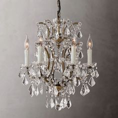 a crystal chandelier with candles hanging from it