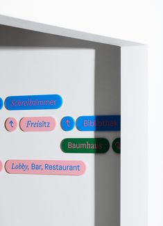 several different colored stickers on the back of a refrigerator door that says, baumhauss