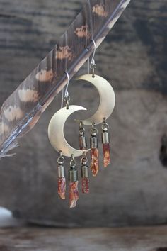 These unique bohemian earrings are created from raw orange kyanite quartz. They are hung from handcrafted sterling silver hooks, brass crescent moons and have been carefully set into antique brass end caps. These earrings are lightweight and comfortable, delicate and feminine pieces, the perfect accessories to compliment any bohemian, tribal style! Kyanite known as the stone of "creativity". Orange Kyanite instills a sense of child-like joy in all of us, enabling us to put our imaginations to wo Orange Kyanite, Kyanite Crystal, Bohemian Earrings, Quartz Earrings, Boho Stil, Earrings Boho, Precious Gemstones, Handmade Sterling Silver, Crescent Moon