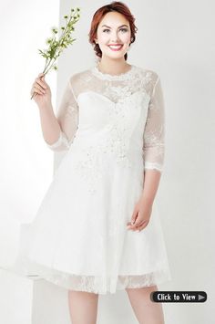 a woman in a short white dress holding a flower and posing for the camera with her hands on her hips