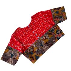 Add a touch of modern elegance to your wardrobe with this Red ikat cotton Blouse. The Pen Kalamkari Elephant border adds an exquisite detail, while the buttons on the back and sleeve edges provide a stylish twist. This blouse effortlessly captures a modish appeal that will elevate any outfit. Item : Blouse  material : Handloom  cotton Ikkat Size fits 36/42 ( Margins Included) Colour : Red Sleeve length :  10.5 inches Back Neck : High Neck Front Neck : 6.5 inches - U Neck Padding : No Lining : Ye Cotton Ikat Print Long Sleeve Top, Long Sleeve Cotton Top With Ikat Print, Red Bohemian Blouse With Kalamkari Print, Fitted Cotton Handloom Blouse Piece, Multicolor Ikat Print Blouse For Festivals, Traditional Ikat Print Saree Blouse, Festive Ikat Print Blouse For Festivals, Festive Cotton Tops With Printed Motifs, Long Sleeve Cotton Ikat Print Blouse