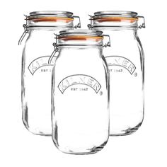 a glass jar with a metal lid and handle on the top, sitting against a white background