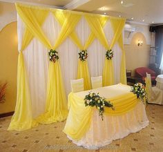 a banquet room decorated in yellow and white