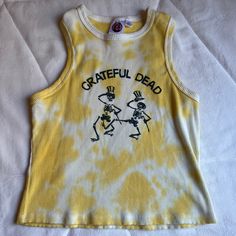 Grateful Dead Yellow Tie Dye Tank. Size Youth Large/ Women’s Small. Never Worn. Please Leave A Comment Below If You Have Any Questions Or Comments, Thank You! I Also Have Lots Of Other Super Cute Listings To Check Out! Offers Welcome And Encouraged! Stretch Yellow Y2k Tops, Yellow Stretch Y2k Top, Fun Yellow Tops For Fall, Fun Yellow Fall Tops, Yellow Y2k Tank Top For Summer, Yellow Fitted Y2k Top, Fitted Yellow Y2k Tops, Yellow Sleeveless Y2k Top, Yellow Fitted Y2k Tank Top