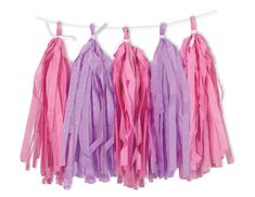 pink and purple tissue tassels hanging on a clothes line