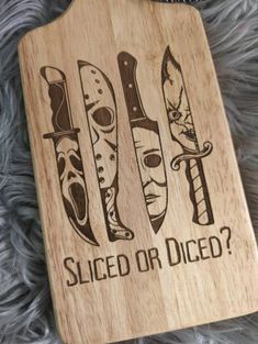 a wooden cutting board that says sliced or diced? with knives on the front