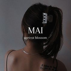 the back of a woman's head with words that read mai aprroot blossom