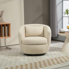 a white chair sitting on top of a rug next to a table