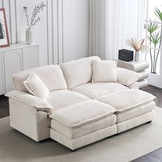 a white couch sitting on top of a hard wood floor