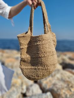 Discover Eco-Friendly Handmade Jute Beach Bag, perfect for summer vacations, this stylish and useful beach bag features a lining for added protection and large capacity to carry your family's essentials. Made from sustainable jute, it combines eco-friendliness with functionality,, making your beach days more enjoyable and organized. Model: Handmade Jute Beach/Everyday Bag Size: 30cm Height - 35 cm Width - Bottom 30 cm radius Material: Eco-Friendly Jute Rope Desing: Sustainable Summer Stylish Use Beach Bag With Braided Handles, Summer Woven Sand-colored Shoulder Bag, Sand-colored Shoulder Bag For Summer Travel, Beachy Sand-colored Beach Bag With Braided Handles, Spring Beach Sand-colored Straw Bag, Sand-colored Straw Bag For Summer Beach, Beachy Sand-colored Straw Bag, Eco-friendly Lightweight Bags For Beach Season, Bohemian Beige Beach Bag For Beach Season