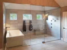 a bath room with a tub a sink and a window