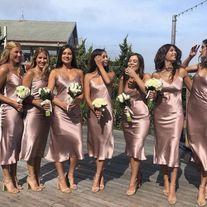 a group of women standing on top of a wooden deck