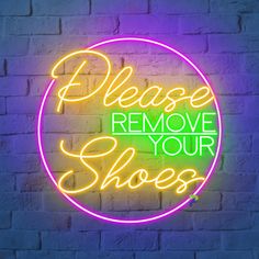 a neon sign that says please remove your shoes