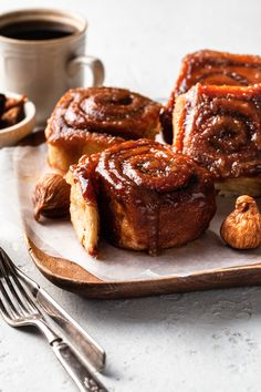 cinnamon rolls on a plate with nuts and coffee