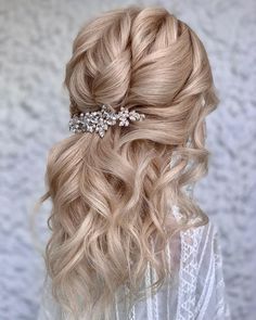 a woman with blonde hair wearing a wedding hairstyle