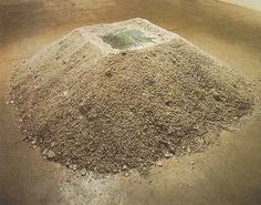 a pile of dirt sitting on top of a cement floor