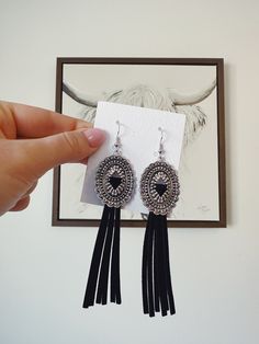 "Adorable pair of black suede fringe concho earrings! Get these for yourself or a cute little gift for a friend! Earrings feature: ✦ Black suede fringe approximately 3\" long ✦ Lightweight earrings, perfect for concerts, festivals or rodeos ✦ Silver embossed concho These cute and fun earrings are sure to be your new go-to earrings! - Boondock Bling Visit our storefront for more Western themed jewelry and accessories!" Adjustable Concho Earrings For Festival, Adjustable Southwestern Black Earrings, Trendy Black Fringe Jewelry, Southwestern Black Festival Earrings, Concho Earrings, Jewelry Western, Western Earrings, Southwestern Jewelry, Lightweight Earrings