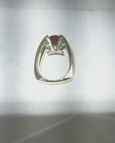 Eddie Sakamoto custom made 18k yellow gold ring. Set, suspended like, in a 4 prong head is an 2.75 carat red Rhodalite Garnet. The stone is a bright red. The 2 round diamonds are set in a tight prong style setting. The diamonds weigh .20 carat with Vs1 clarity and F-G color. A statement for sure. The band weighs 18.5 grams and is a size 8 Eddie Sakamoto is a well known Northwest designer. Modern Red Diamond Ring, Modern 14k Gold Red Rings, Modern Ruby Diamond Ring, Modern Formal Ruby Ring, Modern 14k Gold Ruby Ring With Polished Finish, Modern Ruby Ring With Polished Finish In 14k Gold, Modern Round Ruby Ring, Modern White Gold Ruby Ring, Modern Ruby Promise Ring With Polished Finish