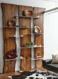 a living room filled with furniture and wooden shelves next to a cowhide rug on top of a hard wood floor