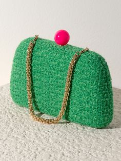 Meet your favorite fall clutch, the Lana Minaudiere from Shiraleah. This versatile bag features a trendy tweed texture in a chic green color pattern with a pink push lock closure. With its interchangeable single handle and cross-body chain, this little purse can be worn as a clutch, a mini bag, or a cross-body! The Lana Minaudiere effortlessly exudes style and sophistication. Pair with other items from the Shiraleah collection to complete your look! Shiraleah is a trend-driven lifestyle brand fo Green Clutch Evening Bag, Green Clutch With Chain Strap, Green Crossbody Clutch For Party, Green Clutch With Chain Strap For Formal Occasions, Green Formal Clutch With Chain Strap, Formal Green Clutch With Chain Strap, Green Pouch Clutch With Detachable Handle, Trendy Green Pouch Clutch, Green Pouch Clutch With Detachable Strap