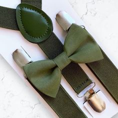 Olive Green Bow Tie & Olive Suspenders- The Perfect Wedding Look! Our olive bow tie & suspenders is a great choice for family photos, wedding, ring bearer outfit, birthday celebration or any other special occasion. ❤ **Please Specify Above**  SET- Bow Tie and Suspenders SUSPENDERS- One Pair of our Quality Suspenders BOW TIE- One Bow Tie on white elastic strap or alligator clip Small: 9 months- 4 years *Bow Tie: 3.5in wide *Suspenders: Elastic, Y Back, 16in- 27in Medium: 5 years- 12 years *Bow Ti Classic Wedding Belts And Suspenders With Bow Tie, Groom's Bow Tie With Suspenders, Dapper Suspenders For Wedding, Dapper Wedding Suspenders, Elegant Adjustable Belts And Suspenders For Wedding, Bow Tie And Suspenders Set For Father's Day Party, Adjustable Ribbon Bow Tie For Wedding, Classic Adjustable Bow For Groom, Adjustable Satin Bow Tie For Groom