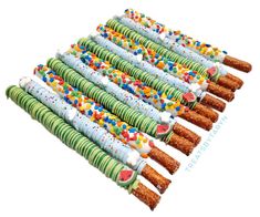 a bunch of candy sticks with sprinkles on them