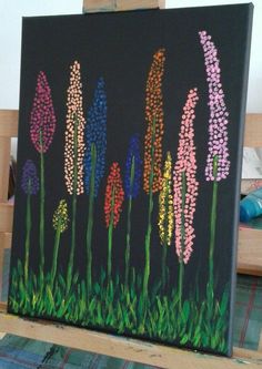 an easel with some flowers painted on it