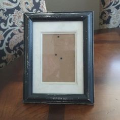 a black and white frame sitting on top of a wooden table