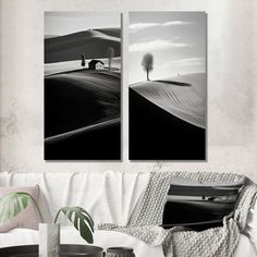 two black and white pictures hanging on the wall above a couch in a living room