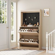 a wooden shoe rack with several pairs of shoes in it next to a stair case