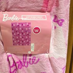 a pink towel with the word barbie written on it in white and purple spray paint