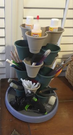 a stack of cups with toothbrushes and other items in them