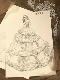 a drawing of a woman in a wedding dress on top of a piece of paper