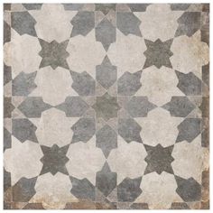 an old tile floor with star designs on the top and bottom, in grey and white