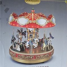 an old fashioned merry go round with horses on it's sides and mirrors in the middle