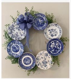 a wreath made out of blue and white plates