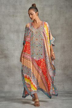 Multi colored kaftan with tribal, abstract, floral and chevron prints all-over and embroidered bodice panel.
Components: 1
Pattern: Printed, Embroidered
Type Of Work: Tribal
Neckline: V Neck
Sleeve Type: Batwing
Fabric: Modal Satin
Color: Multi Color
Occasion: Resort - Aza Fashions Bohemian Multicolor Print V-neck Kaftan, Multicolor Printed Motifs Kaftan For Navratri, Multicolor Printed Kaftan For Navratri, Bohemian Kaftan With Printed Motifs For Festive Occasions, Bohemian V-neck Kaftan With Printed Motifs, Multicolor Printed V-neck Kaftan, V-neck Kaftan With Boho Print In Patterned Color, Multicolor V-neck Kaftan With Printed Motifs, V-neck Patterned Kaftan With Boho Print