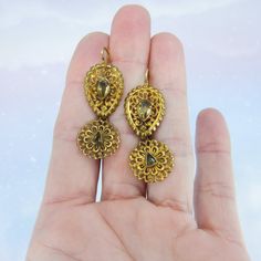 "These earrings are beyond exquisite, BEYOND. I encourage you to zoom way in on the pics and look at the absolutely incredible metal work on these beauties, it is phenomenal. Made circa 1850, very possibly earlier, these earrings are done in the pendeloque style popularized in the mid-1700's. Bezel set foil-backed citrines sit atop hand sawn scrolling metalwork that is full of fine detail. And as if things couldn't get any better, these are also day/night! And they're not just day/night with two Victorian Style Ceremonial Earrings For Pierced Ears, Victorian Style Ceremonial Dangle Earrings, Antique Earrings With 17 Jewels For Ceremonial Occasions, Victorian Hallmarked Earrings For Ceremonial Occasions, Victorian Gold Plug Earrings, Antique Filigree Earrings For Ceremonial Occasions, Victorian Yellow Gold Earrings With Intricate Design, Antique 22k Yellow Gold Earrings, 22k Gold Victorian Ceremonial Jewelry